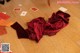 A pair of red lingerie sitting on top of a wooden floor.