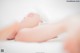 A woman laying on a bed with her legs crossed.