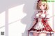 Anime girl in a red and white dress posing for a picture.