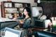 A woman sitting at a counter in a coffee shop.