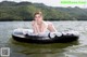 A woman in a pink bikini laying on an inflatable raft in the water.